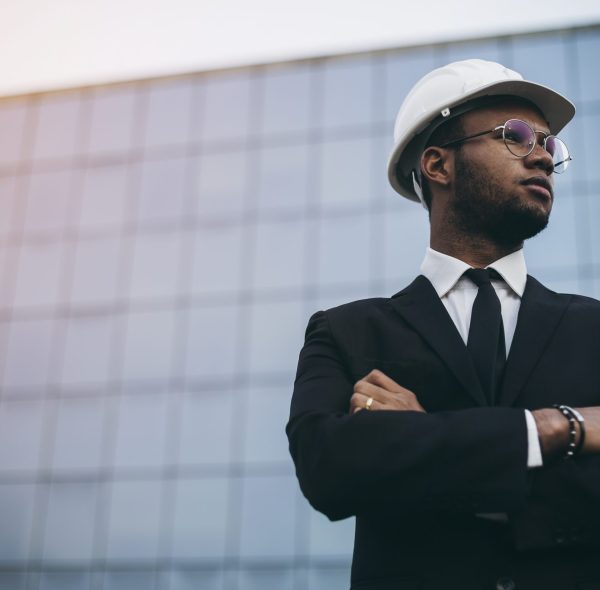 African engineer in front of a skyscraper. The business world